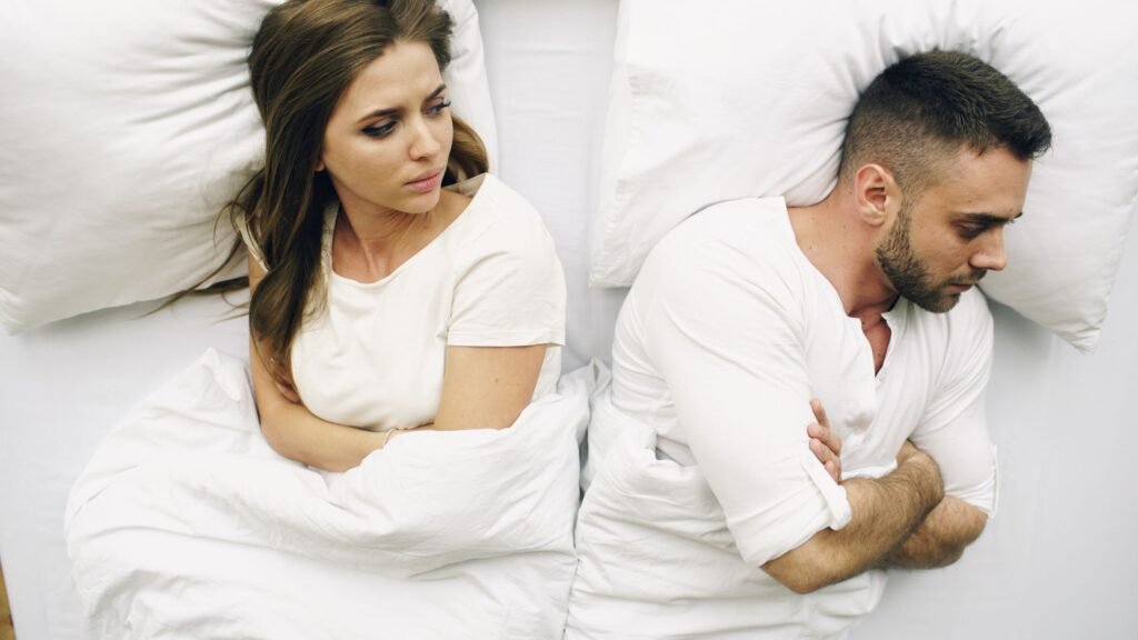 Lie detector test for cheating – couple lying in bed after an argument over suspected infidelity