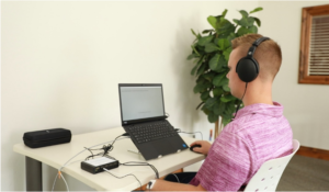 Person undergoing an EyeDetect lie detector test wearing headphones
